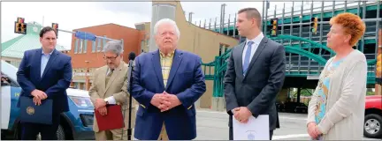  ?? DANIELLE RAY PHOTOS / SENTINEL & ENTERPRISE ?? Joe Byrne, center, thanks those who gathered for the dedication of Gerry Martel Square at the corner of North and Main streets in Fitchburg on Wednesday morning, honoring his ‘very best friend.’ He’s flanked by, from left, state Sen. John Cronin, Mayor Stephen Dinatale, state Rep. Michael Kushmerek and City Council member Amy Green. Below, Kushmerek presents Nadine ‘Toddy’ Martel with a citation at the dedication.