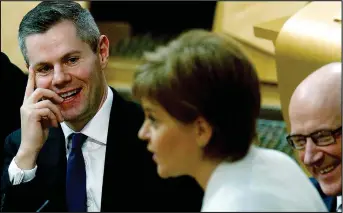  ??  ?? Budget deal: Nicola Sturgeon with Derek Mackay, whose Budget will hit many earners