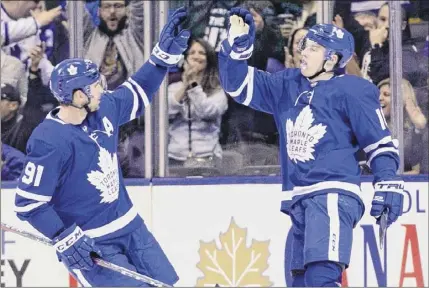  ?? Frank Gunn / The Canadian Press via AP ?? Toronto Maple Leafs right wing Mitchell Marner, right, celebrates his goal with center John Tavares during the third period of a 5-3 win over the New York Rangers on Saturday in Toronto. Marner scored twice in the win.