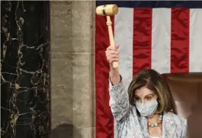  ?? GEtty IMAgES ?? IF I HAD A HAMMER: Speaker of the House Nancy Pelosi, D-Calif., waves a gavel during the first session of the 117th Congress in the House Chamber at the Capitol in Washington, D.C.