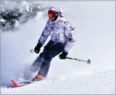  ?? ?? A competitor in the Junior Freeride whips up a big cloud of snow near the finish line.