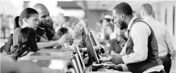  ??  ?? File photo shows passengers presenting their travel documents to check in at the American Airlines ticket counter at Dulles Internatio­nal Airport in Dulles, Virginia. — Reuters photo