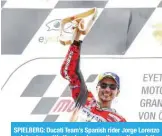  ??  ?? SPIELBERG: Ducati Team’s Spanish rider Jorge Lorenzo celebrates with the trophy on the podium of the Austrian MotoGP Grand Prix at the Red Bull Ring in Spielberg, Austria yesterday.— AFP