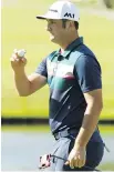  ??  ?? Jon Rahm acknowledg­es the gallery after making par on the 16th green Thursday.