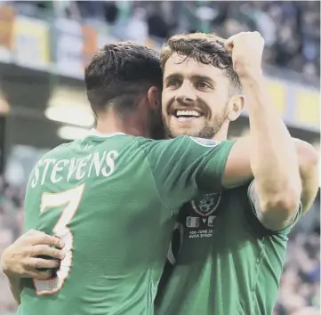  ??  ?? 0 Substitute Robbie Brady, right, celebrates after scoring the Republic’s second last night.