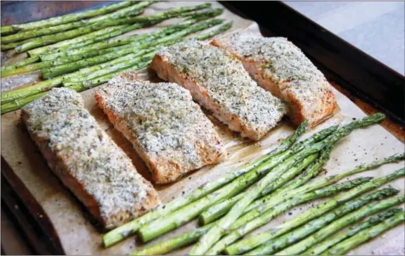  ?? MELISSA D’ARABIAN VIA AP ?? This photo shows a sheet-pan supper of salmon and asparagus in Coronado a recipe by Melissa d’Arabian.