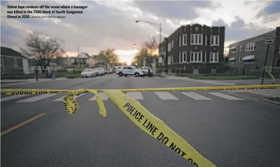  ?? JOSHUA LOTT/GETTY IMAGES ?? Yellow tape cordons off the scene where a teenager was killed in the 7300 block of South Sangamon Street in 2016.