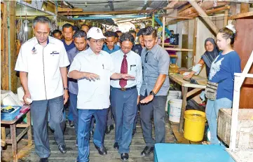  ??  ?? Shafie with Bianus inspecting the state of cleanlines­s in Semporna town yesterday.