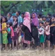  ??  ?? Rohingya Muslims stand in line for food near Balukhali refugee camp in Cox’s Bazar, Bangladesh.