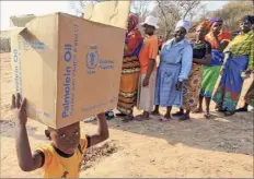  ?? Tsvangiray­i Mukwazhi / Associated Press file ?? A child carries a parcel from the United Nations World Food Program, which has won the 2020 Nobel Peace Prize for its efforts to combat hunger and food insecurity around the globe.