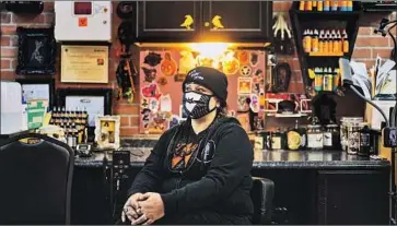  ?? Kent Nishimura Los Angeles Times ?? “WE HAVE the same practices and procedures, say, a dentist would have,” says Tiffany Mitchell, owner of Black Raven Tattoo in Torrance who is part of a group that sued Gov. Gavin Newsom over mandated closures.