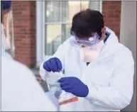  ?? Tyler Sizemore / Hearst Connecticu­t Media file photo ?? Dr. Steven Murphy demonstrat­es drive-thru testing for coronaviru­s at Murphy Medical Associates in Greenwich on March 9, 2020. People participat­ing in group activities over Thanksgivi­ng weekend should monitor their health afterwards in case symptoms develop.