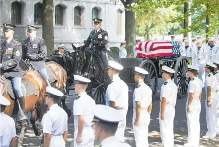  ?? Photo / AP ?? The caisson bearing the body of Senator John McCain moves towards the academy cemetery in Annapolis.