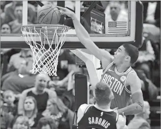  ?? DARRON CUMMINGS/AP PHOTO ?? Jayson Tatum dunks over Indiana’s Domantas Sabonis during the first half of the Celtics’ 112-111 win over the Pacers on Monday night in Indianapol­is.