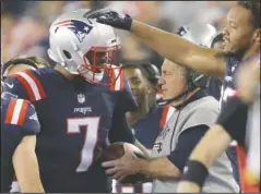  ?? The Associated Press ?? PAT’S HAND: New England third-team quarterbac­k Jacoby Brissett (7) hands the football to head coach Bill Belichick after rushing for his first career touchdown against the Houston Texans Thursday night. Despite Tom Brady’s fourgame suspension and an...