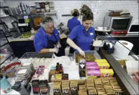  ?? LYNNE SLADKY — THE ASSOCIATED PRESS ?? Emma Gonzalez, left, and Lidices Ramos, right, make empanadas at the Mendez Fuel convenienc­e store in Miami. There’s no stale doughnuts and cold coffee at the store. Instead, customers can get their caffeine fix with an iced matcha and grab some vegan empanadas or an acai bowl for the road.