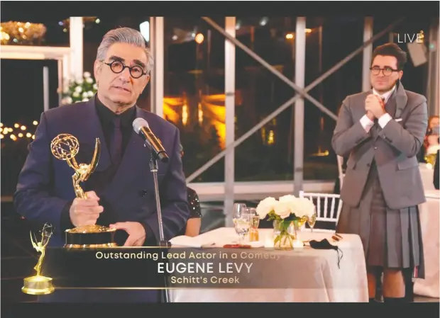  ?? Image Group LA / ABC / AFP ?? Canadian actor Eugene Levy speaks after receiving his Emmy while his son, actor/director/writer Daniel Levy, watches during the 72nd Primetime
Emmy Awards ceremony held virtually on Sunday. Daniel Levy took home three Emmys himself shortly after Eugene Levy’s speech.