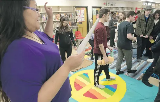  ?? PHOTOS: PIERRE OBENDRAUF ?? Nina Segalowitz introduces students to a blanket exercise during Aboriginal Day at Lindsay Place High School in Pointe-Claire. Students from more than a dozen high schools took part in a variety of activities as part of an effort to raise awareness...