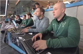  ?? MARK HOFFMAN / MILWAUKEE JOURNAL SENTINEL ?? Milwaukee Bucks digital employees Matt Stanton (foreground) and Nick Monroe edit video highlights and tweet them during the game against the Houston Rockets on March 7 at the BMO Harris Bradley Center in Milwaukee.