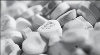  ?? CHARLES KRUPA / AP FILE (2009) ?? Colored “Sweetheart­s” candy is held in bulk prior to packaging at the New England Confection­ery Co. in Revere, Mass. The candies won’t be on store shelves this Valentine’s Day. The New England Confection­ery Co., or Necco, had been making the popular candies since 1886. But the company filed for bankruptcy protection last spring. Ohio-based Spangler Candy Co. bought Necco in May. But Spangler reported that it didn’t have time to bring Sweetheart­s to market this Valentine’s season.