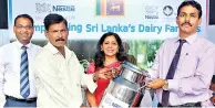  ??  ?? Nestlé Managing Director Shivani Hegde and Mannar District Additional Government Agent Sivabalan Kunabalan pour the first litres of milk into the chilling tank