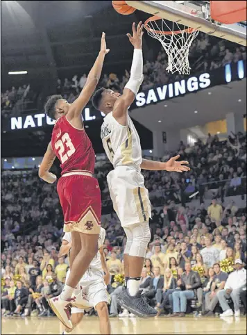  ?? HYOSUB SHIN / HSHIN@AJC.COM ?? Georgia Tech’s Josh Okogie goes up for a shot past Boston College’s Mike Sagay as the Yellow Jackets come back from a disastrous first half, down 22-15, to beat the Eagles at McCamish Pavilion on Saturday.