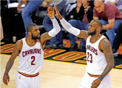  ?? AFP ?? Kyrie Irving (left) and LeBron James were nearly unstoppabl­e as they powered defending champion Cleveland to a 137-116 win. —