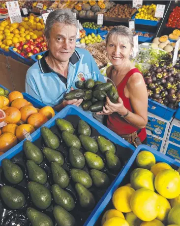  ?? Picture: ANNA ROGERS ?? COSTLY HABIT: Smithfield Local Fruit and Veg part-owner Bob Connery and supervisor Kelly Anderson with some avocados that people have bruised by squeezing them.