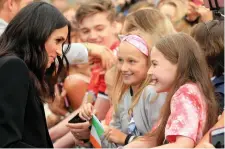  ??  ?? Meghan Markle meets with Emma Boden and Sophie Maher during the meet and greet in the grounds of Trinity College. Photo: Gerry Mooney