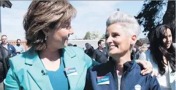  ?? JONATHAN HAYWARD/THE CANADIAN PRESS ?? B.C. Liberal Leader Christy Clark shares a laugh with local candidate Paris Gaudet as she makes a campaign stop at Seamor Marine in Nanaimo on Thursday.