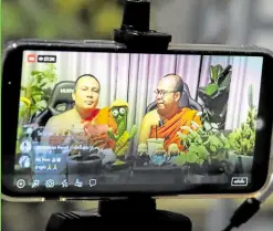  ?? —PHOTOS BY REUTERS ?? SOCIAL MEDIA STARS Phra Maha Sompong Talaputto and Phra Maha Paiwan Warawanno mix Buddhist teachings with modern life advice and a hefty dose of humor in their chat show on Facebook Live at a temple in Bangkok.