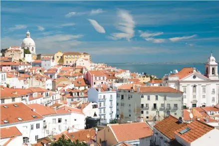  ?? CAMERON HEWITT ?? Breathtaki­ng views are bountiful in Miradouro Santa Luzia, a city of red-tiled roofs on the yawning mouth of the Tejo River.