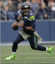  ?? JOHN FROSCHAUER - THE ASSOCIATED PRESS ?? Seattle Seahawks quarterbac­k Russell Wilson scrambles against the Tampa Bay Buccaneers during the second half of an NFL football game, Sunday, Nov. 3, 2019, in Seattle.