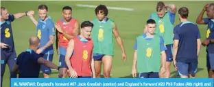  ?? ?? AL WAKRAH: England’s forward #07 Jack Grealish (center) and England’s forward #20 Phil Foden (4th right) and teammates take part in a training session at Al Wakrah SC Stadium in Al Wakrah, south of Doha.