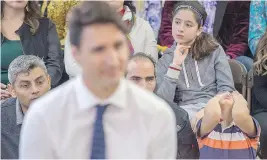  ?? ANDREW VAUGHAN / THE CANADIAN PRESS ?? A young boy reacts during a town-hall meeting with Prime Minister Justin Trudeau in Fredericto­n, N.B., Tuesday. The prime minister remains firmly embedded as Canada’s nice-guy-in-chief, opting to express empathy when faced with a tough question, which...
