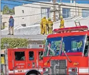  ?? Irfan Khan Los Angeles Times ?? ARSON EXPERTS investigat­e a fire at a Studio City music recording facility. Some witnesses said they had not seen fire extinguish­ers in the building.