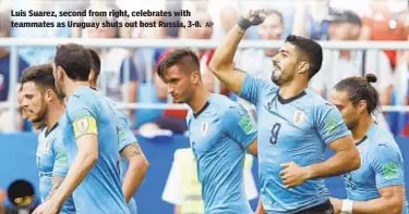  ?? AP ?? Luis Suarez, second from right, celebrates with teammates as Uruguay shuts out host Russia, 3-0.