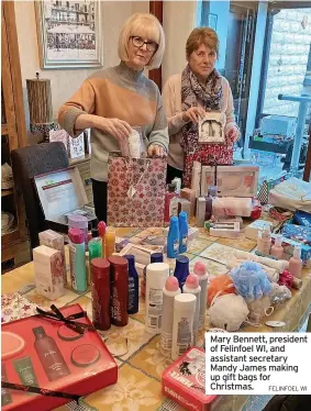  ?? FELINFOEL WI ?? Mary Bennett, president of Felinfoel WI, and assistant secretary Mandy James making up gift bags for Christmas.