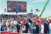  ?? KENNETH FERRIERA/LINCOLN JOURNAL STAR ?? Former NFL player Jack Brewer, on screen, leads a prayer during a rally for Nebraska Republican gubernator­ial candidate Charles Herbster Sunday.