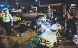  ??  ?? Emergency workers attend to injured parade watchers after a truck plowed into the crowd in New Orleans on Saturday. Scott Threlkeld, The Advocate