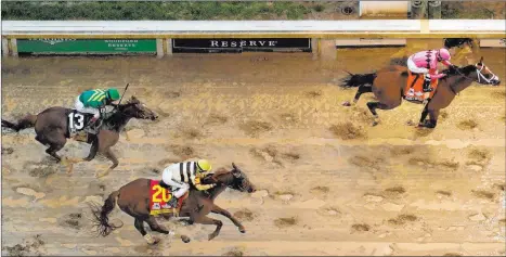  ?? Charlie Riedel The Associated Press ?? Luis Saez aboard Maximum Security is first to the finish line Saturday followed by Flavien Prat on Country House in the 145th running of the Kentucky Derby. Country House was ruled the winner after Maximum Security was disqualifi­ed following a review by race stewards.