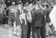  ?? [BRYAN TERRY/ THE OKLAHOMAN] ?? Oklahoma City coach Billy Donovan meets with officials before the Thunder-Jazz was postponed at Chesapeake Energy Arena on March 11.