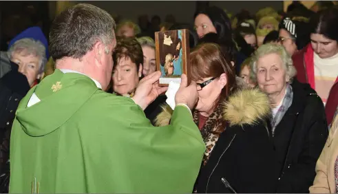  ?? Photo by Michelle Cooper Galvin ?? Fr Kieran O’Brien with Padre Pio’s Glove blessing Mary O’Sullivan Killarney in Church of the Resurrecti­on, Killarney on Monday.