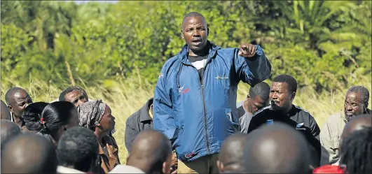  ?? Picture: SUNDAY TIMES ?? Sikhosiphi Rhadebe speaks with members of the community in Xolobeni, in the Eastern Cape. Rhadebe was chairman of the Amadiba Crisis Committee when he was assassinat­ed in March.