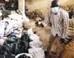  ??  ?? Nigerian drug enforcemen­t agents inspect a pile of seized codeine cough syrup in Kano