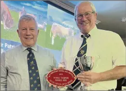  ?? ?? JUDGE JIM Scott (left) pictured with Patrick Greed (Killerton) who had the overall champion pedigree herd