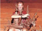  ?? HERALD-TRIBUNE ARCHIVE ?? Riverview High head football coach John Sprague shows off some of his hardware in 1986.