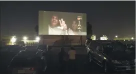  ??  ?? Dave Franco, director/co-writer of “The Rental,” and his wife, cast member Alison Brie, are seen on a movie screen as they take part in a Zoom Q&A session from their car following an advance screening of the film at the Vineland Drive-In in City of Industry, Calif.