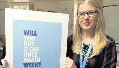  ??  ?? ●● Karen Lloyd, digital marketer at East Cheshire Hospice, with one of the slogans from the charity’s Will Week campaign