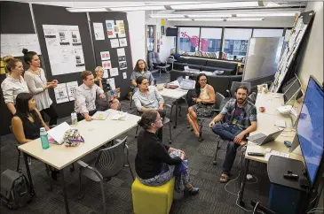  ?? PHOTOS BY RICARDO B. BRAZZIELL / AMERICAN-STATESMAN ?? Members of the city’s Design, Technology and Innovation Fellowship program meet to discuss progress on initiative­s on Wednesday. The program has been in operation for one year.